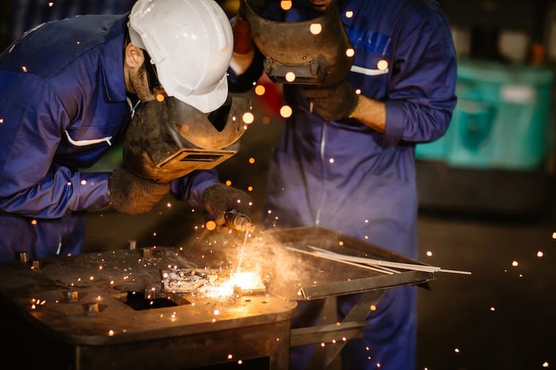 two welders working on a weld