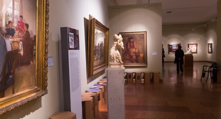 A statue on a pedestal in a museum